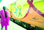 A woman passes by the Red Ribbon Express in Haridwar on Tuesday