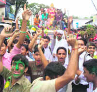 Devotees dance in Kangra town as a procession takes an idol of Lord Ganesha to the Banner river for immersion on the eve of Anant Chaudas.