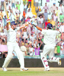 After snatching a victory for India from a no-win situation, VVS Laxman (L) heads for a celebration hug with Pragyan Ojha on the final day of the opening India-Australia Test in Mohali on Tuesday.