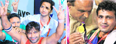 (Left) Anil Kumar celebrates after his gold haul in 96-kg category. Wrestler Ravinder Singh (Right) with coach Satpal.