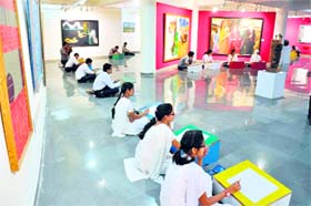 Students participate in a slogan-writing competition during the week-long celebration of the birth anniversary of Mahatma Gandhi at University of Jammu on Tuesday.