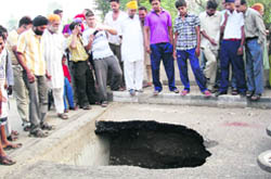 The deep crater formed on the Tibri bridge on the Hoshiarpur-Gurdaspur road 