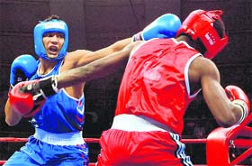 Indias Manoj Kumar (blue) lands a blow on D Lassayo of Sierra Leone