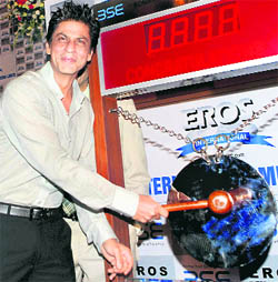 Bollywood actor Shahrukh Khan ringing the bell at Bombay Stock Exchange during the listing of Eros International Media Ltd, in Mumbai on Wednesday