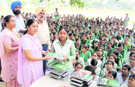 Books being given to students of Girls Senior Secondary School, Bharat Nagar, Ludhiana, on Wednesday.