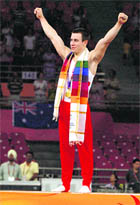 Englands gold medallist Luke Folwell celebrates after winning the artistic mens individual all-around final.