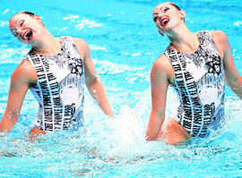 Elosie Amberger and Sarah Bombell of Australia perform in the womens synchronized swimming in New Delhi on Wednesday.