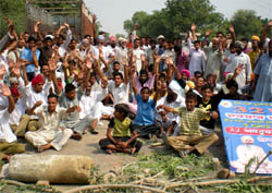 Residents of Har Raipur village block the Bathinda-Pathankot national highway at their village on Thursday.