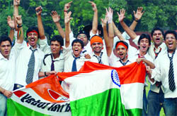 Spectators celebrate as the India medals tally rises in New Delhi