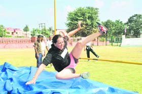 An athlete participates in the high-jump event in the Police Athletics Meet at the Police Lines in Dehradun