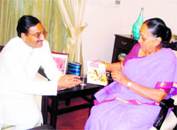 Uttarakhand Chief Minister Ramesh Pokhriyal Nishank presents his book to Governor Margaret Alva in Dehradun on Thursday