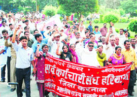 Guest teachers hold a protest against the state government demanding the regularisation of their services in Karnal