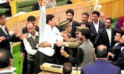 Protesting BJP and Panthers Party MLAs being marshalled out of the state Assembly in Srinagar on Thursday