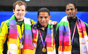 Gold medallist Peter Yukio (C) of Nauru poses with silver medallist Ben Turner (L) of Australia and bronze medallist Raju Sudhir Kumar of India after winning the men's 77kg weightlifting competition at the Commonwealth Games in New Delhi on Thursday. 