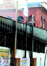 Smoke comes out of one of the chimneys outside the langar hall in the Golden Temple in Amritsar.