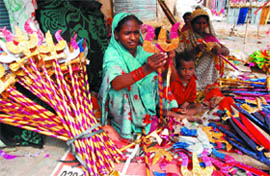 With Dussehra round the corner, artists are busy making toys associated with the festival, including tridents, swords, bows and arrows, in Bathinda on Friday.