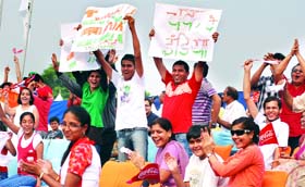Supporters celebrate as the Indian team wins gold in the Women's Team Recurve event at the Yamuna Sports Complex on Friday.