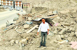 Phunchok stands amid the debris of his store in Leh.