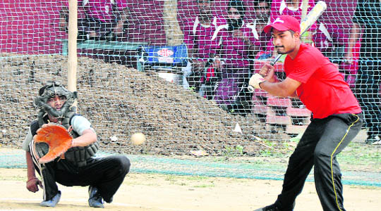 A striker looks on as he leaves the ball during the 6th Senior Ludhiana District Baseball Championship at Guru Nanak Khalsa Girls College, Gujarkhan Campus, Ludhiana, on Friday.