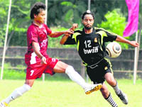 A forward player of the Friends Football Club being checked by an NPS player during the fifth Kanwar Harbans Lal Memorial Football Championship in Chandigarh 