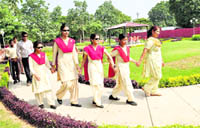 An attendant holds hands of visually challenged children to guide them in Sensory Park, Sector 26, Chandigarh.