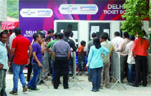 People brave long queues to buy tickets at Talkatora Indoor Stadium in New Delhi on Saturday.