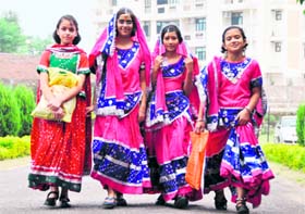 Girls dressed in traditional attire on their way to participate in a dandiya performance in Dehradun on Saturday.