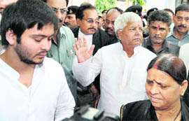 Former Bihar Chief Minister Rabri Devi with her husband and RJD chief Lalu Prasad and son Tejaswi Prasad after filing nomination papers from the Raghopur seat, in Hajipur on Saturday.