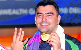 Gagan Narang strikes a pose after winning gold in the 50M rifle shooting in New Delhi on Saturday.
