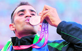 Indias Harminder Singh after winning bronze in mens 20-km walk in New Delhi on Saturday.