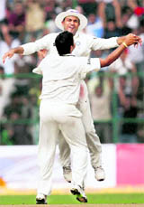 Sehwag and Raina celebrate Pontings dismissal in the second Test in Bangalore on Saturday.