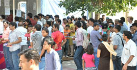 People wait at a ticket window outside the Jawaharlal Nehru Stadium in New Delhi on Sunday. 