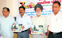 Dr Rakesh Kumar, Secretary, Rural Development (second from left), releases a book in Dehradun on Sunday