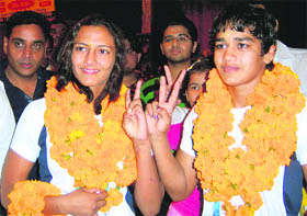 Victorious Two: Geeta Balali and Babita Balali, who won the gold medal and the silver medal, respectively, in wrestling in the Commonwealth Games, show their medals in Rohtak on Sunday. 
