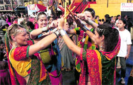 Foreign tourists take part in dandiya as part of religious festivities in Thane, near Mumbai, on Sunday