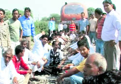 Members of various organisations sit on the railway line in protest at Fazilka on Sunday.