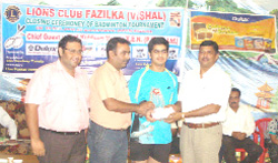Executive Engineer, Powercom, Kuldeep Verma honouring a badminton player during the concluding ceremony of three-day badminton tournament in Fazilka