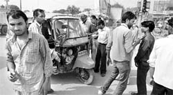 Sher-e-Punjab Auto Union activists stop a haryan auto-rickshaw on the Zirakpur-Kalka highway on Monday.