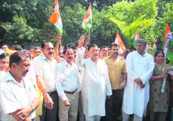 Congress workers hold a demonstration in Dehradun on Monday. 