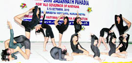 Students perform yoga during the 26th Haryana State Yoga Championship in Kurukshetra.