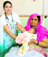 Dr Prabjot Kaur with Sunita (47) and her newborn baby at Guru Nanak Hospital in Karnal.