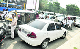 A car that is parked in the middle of the road causes traffic jam in Ludhiana on Monday.