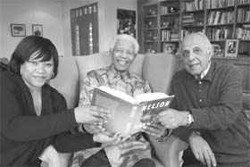 South Africas former President Nelson Mandela poses with a copy of the US edition of his newly released book Conversations with Myself