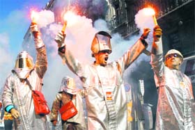 Arcelor Mittal steel workers dressed in protective work suit demonstrate over pension reforms in Marseille