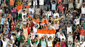 Indians celebrate the hockey teams victory against England in the men's semi-final match at the Major Dhyan Chand National Stadium in New Delhi on Tuesday. 