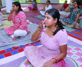 Women practise yoga at Planet Health Museum, Morarji Desai National Institute of Yoga,Ashok Road in New Delhi on Tuesday