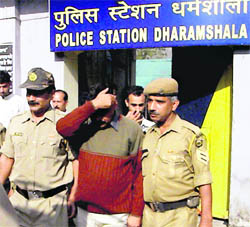 Virender Kumar, the accused in the exam scam case, in front of the police station in Dharamsala