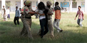Cops drag protesting unemployed ETT teachers from the government middle school in village Jandwala Bhimeshah of Fazilka where Punjab Education Minister Dr Upinderjit Kaur was present.
