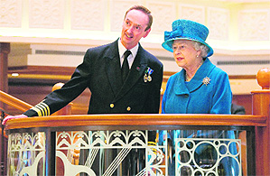 Britain's Queen Elizabeth speaks with the chief of the 'Queen Elizabeth', Capt Chris Wells, during her tour of Cunard's new cruise ship in Southampton on Monday. 'Queen Elizabeth' is on its maiden voyage to the Canary Islands.