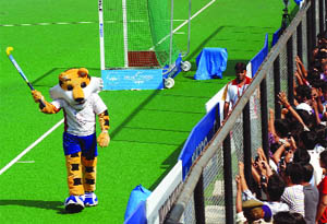 CWG mascot Shera enjoys during the women's hockey final match at the Major Dhyan Chand National Stadium in New Delhi on Wednesday.